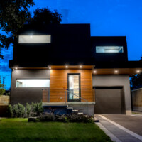 Modern Home, with dark and wood panels, front view at night