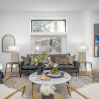 Modern living room with window above painting