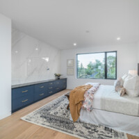 Bedroom with granite accent wall and large window